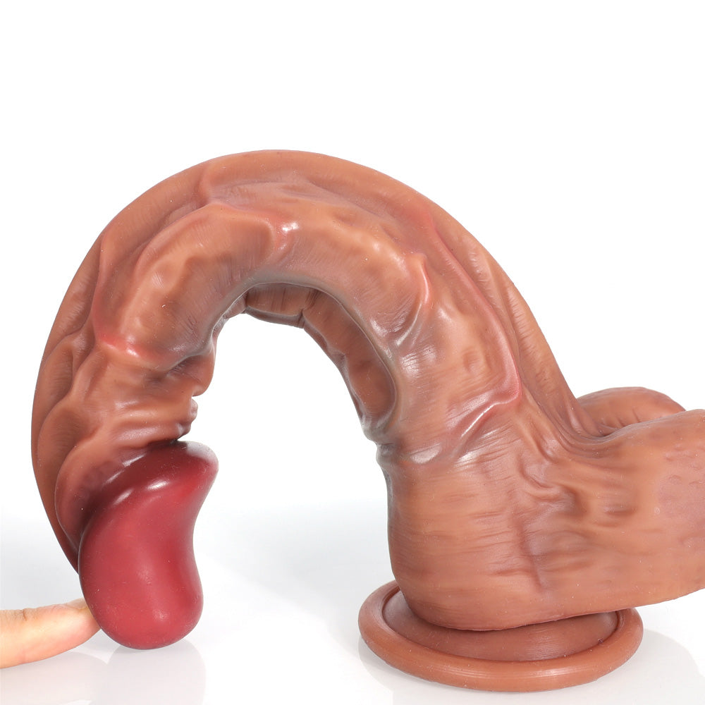 finger pressing curved red dildo tip to show flexibility and tapered design