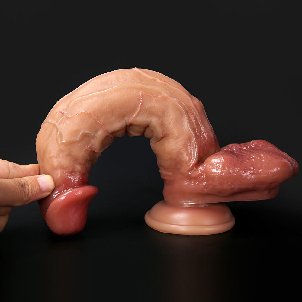 finger pressing down on crowned head to demonstrate flexible shaft and soft silicone surface