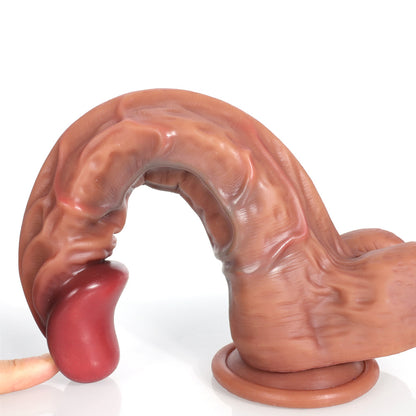 finger pressing curved red dildo tip to show flexibility and tapered design