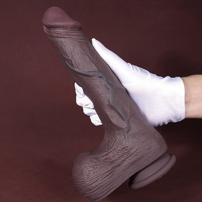 hand holding 10 inch realistic dildo to show girth, soft texture, and suction cup base