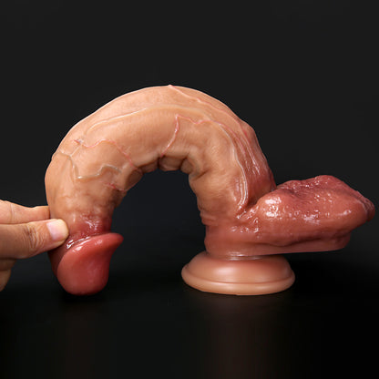 finger pressing down on crowned head to demonstrate flexible shaft and soft silicone surface